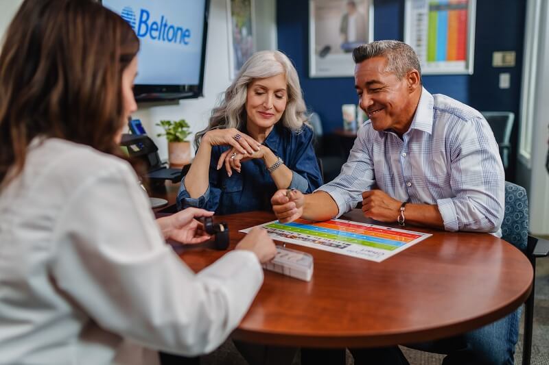 Hearing specialist of Beltone hearing aids with a couple