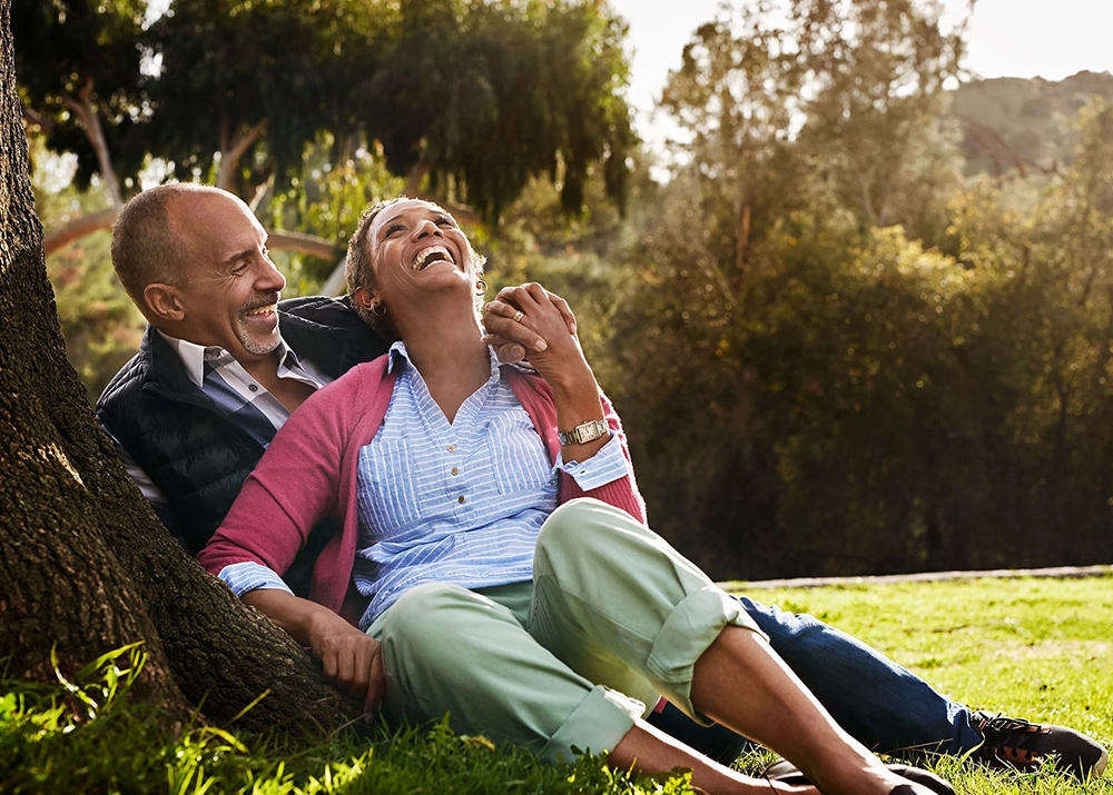 Senior couple smile and laugh in a park